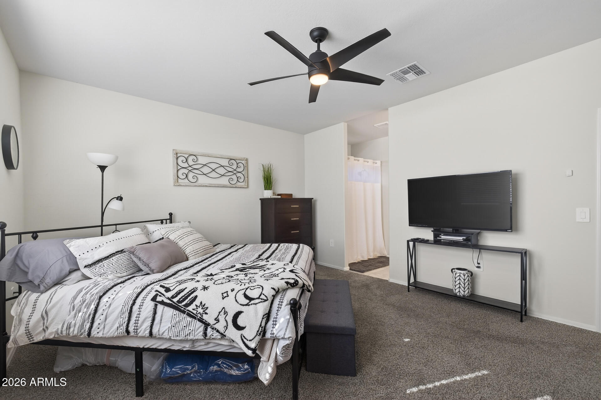 9573 Cotton Road Florence, AZ 85132 - Photo 18 of 46 a bedroom with a bed and a flat screen tv