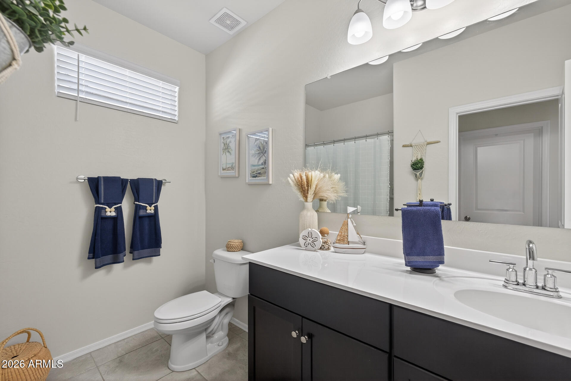 9573 Cotton Road Florence, AZ 85132 - Photo 22 of 46 a bathroom with a toilet sink and mirror