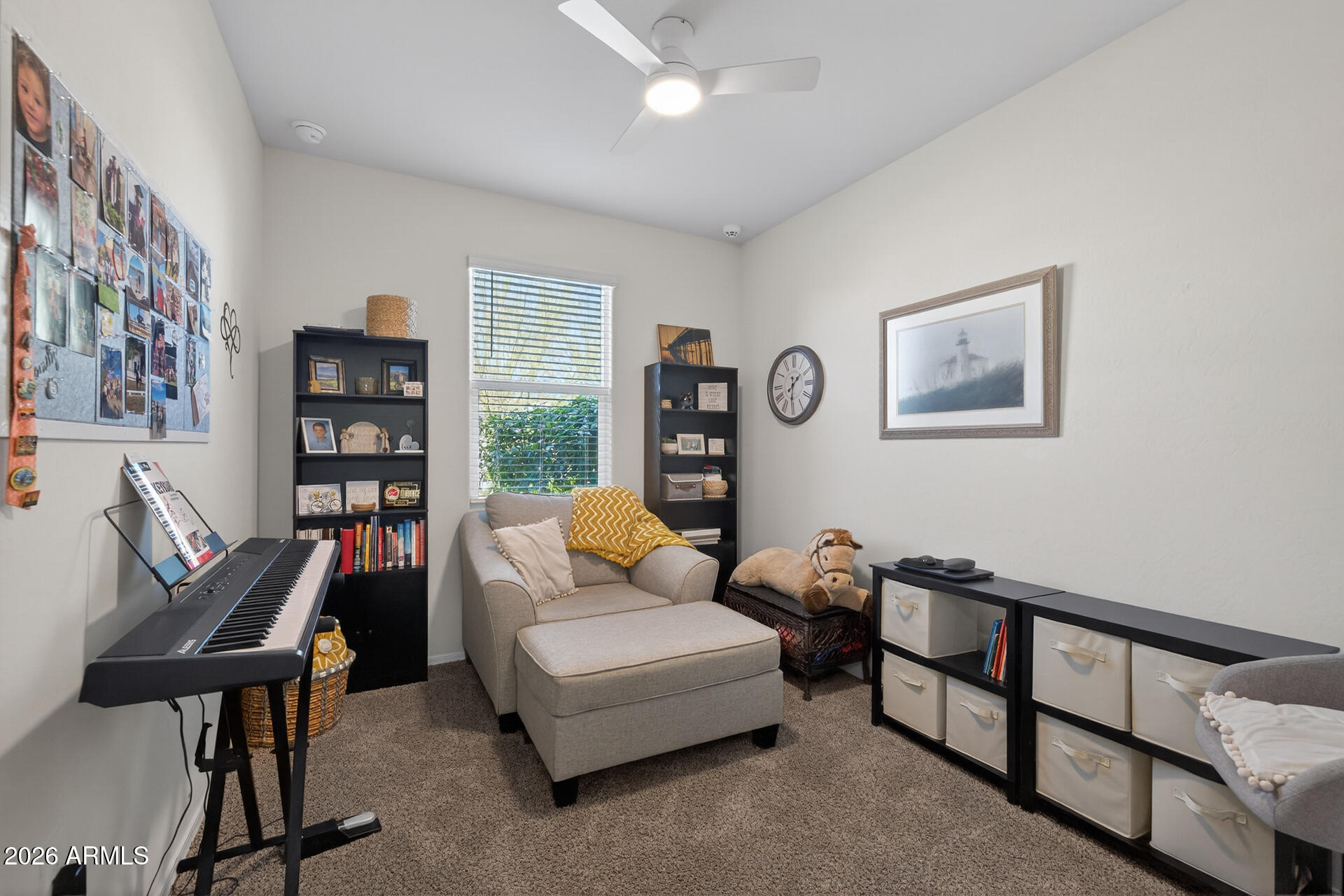 9573 Cotton Road Florence, AZ 85132 - Photo 23 of 46 a living room with furniture a bookshelf and a window