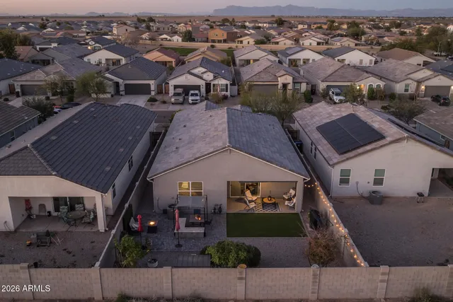 a living room with furniture a bookshelf and a window