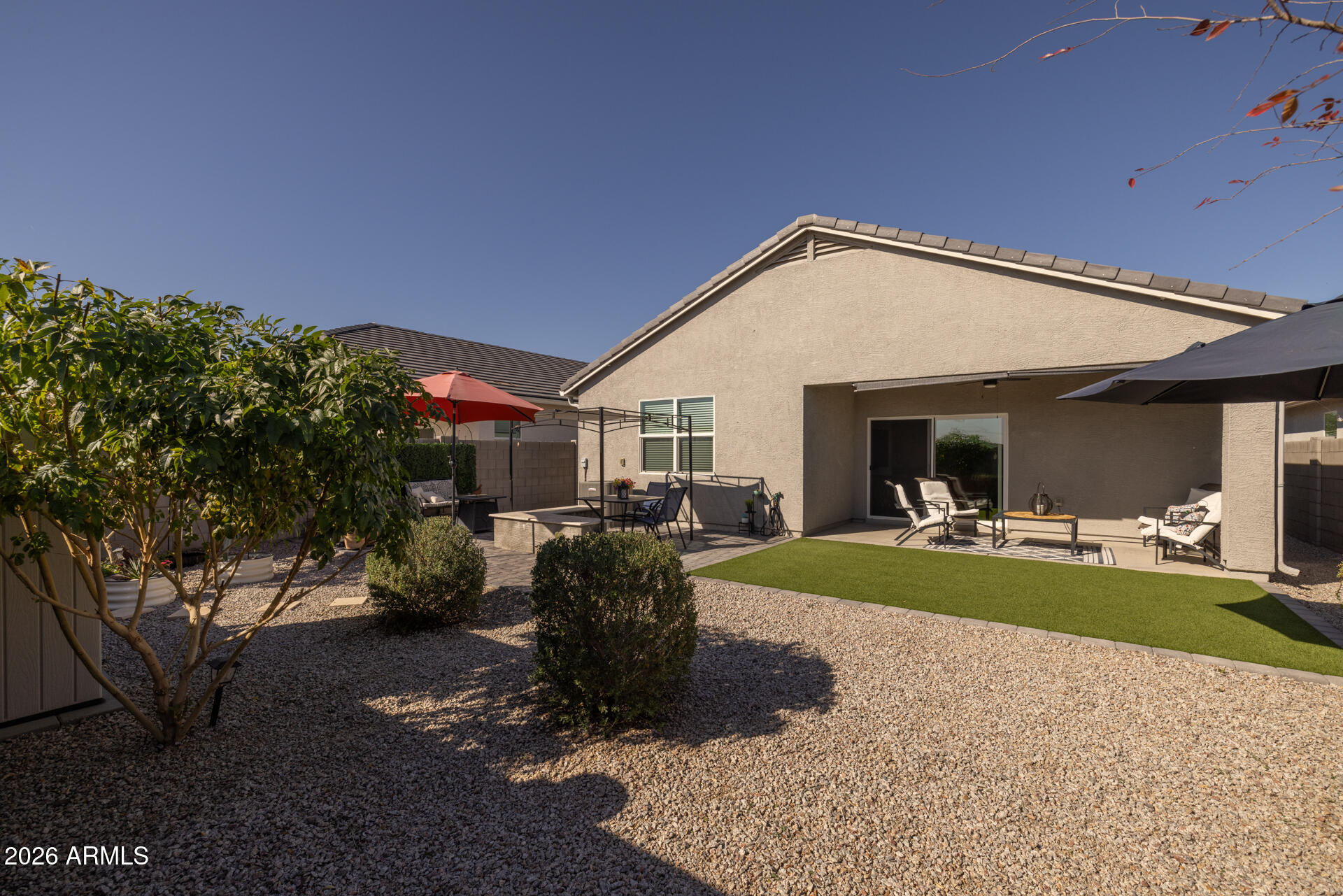 9573 Cotton Road Florence, AZ 85132 - Photo 35 of 46 a view of a house with backyard porch and outdoor seating