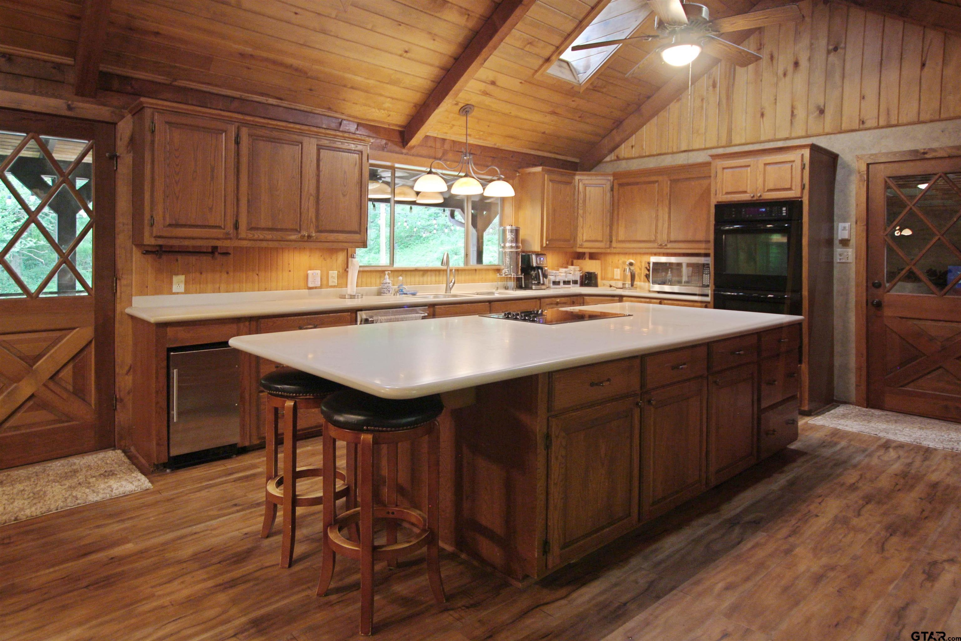 782 Rosie Wady Road Gladewater, TX 75647 - Photo 9 of 48 a kitchen with wooden cabinets and center island