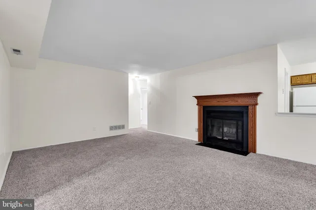 a view of an empty room with a fireplace