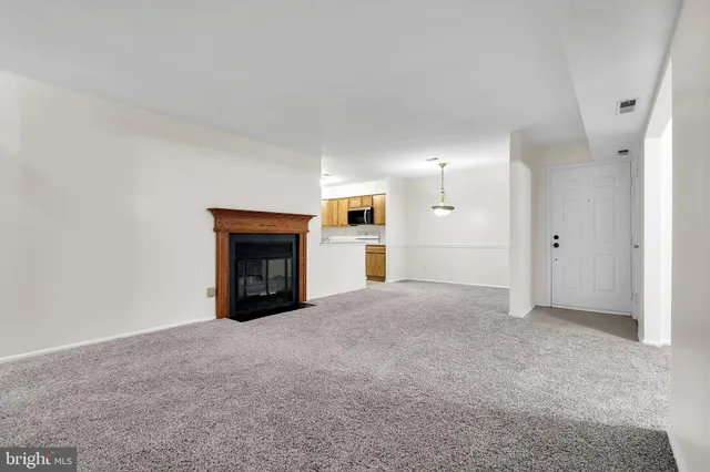 a view of empty room with a fireplace