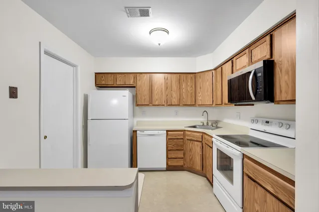 a kitchen with a sink appliances and cabinets