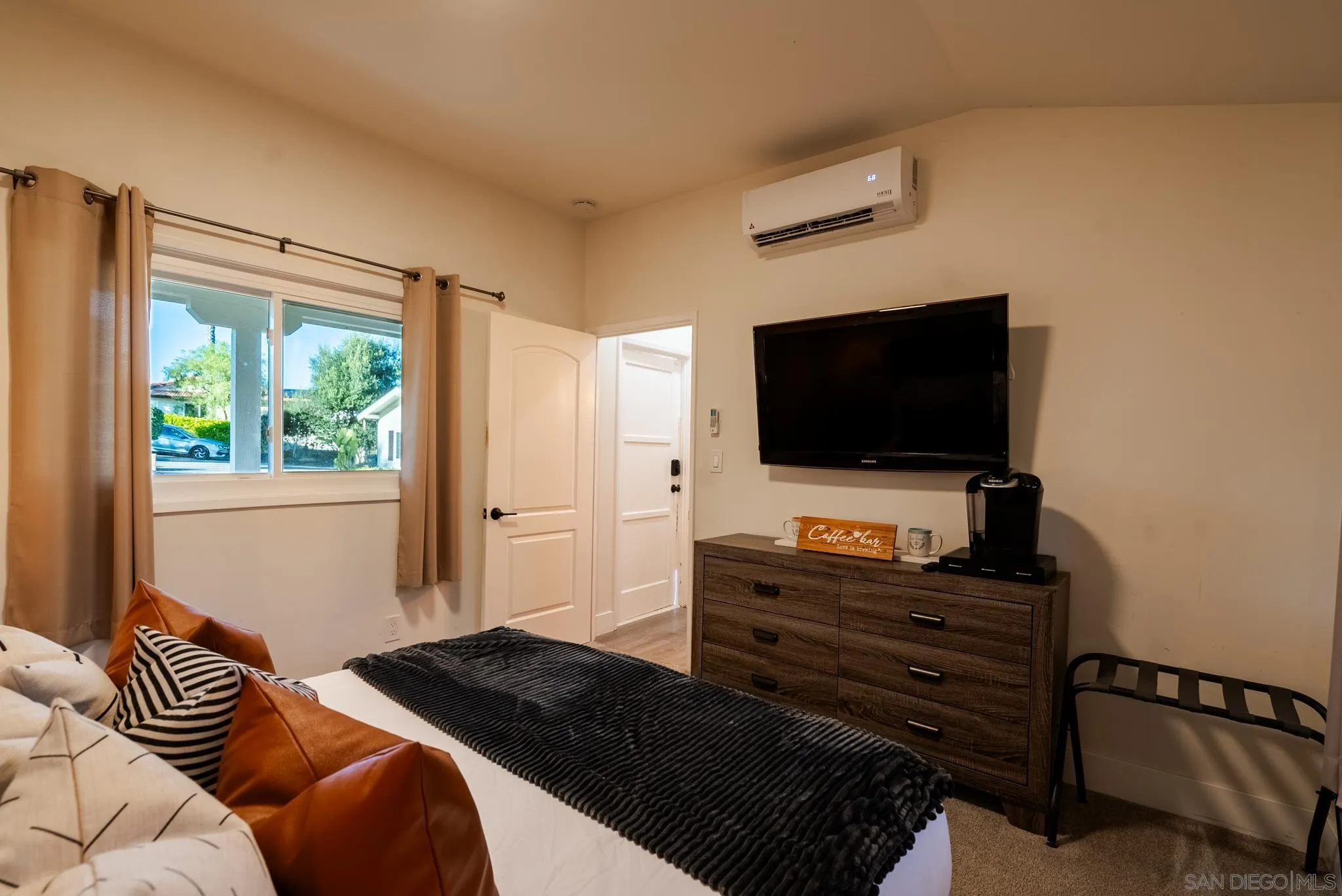 1337 Friends Way Fallbrook, CA 92028 - Photo 37 of 74 a bedroom with a bed and a flat screen tv