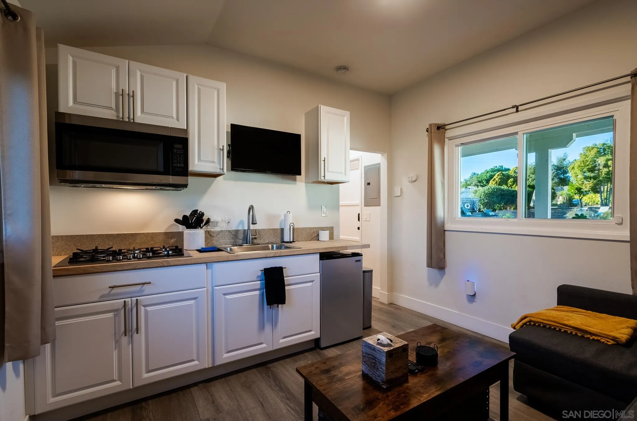 1337 Friends Way Fallbrook, CA 92028 - Photo 38 of 74 a kitchen with stainless steel appliances granite countertop a stove a sink dishwasher a microwave oven and cabinets with wooden floor
