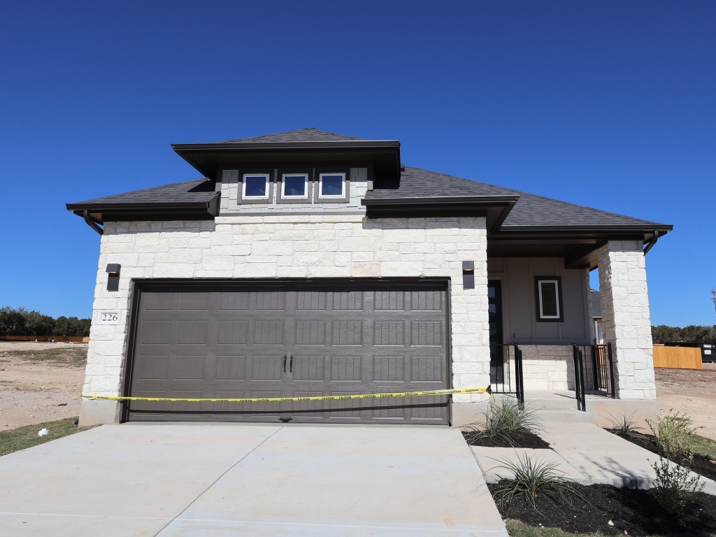 a front view of a house with garage