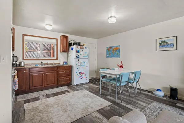 a living room with furniture a piano and a window