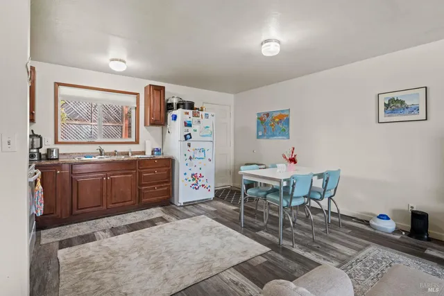 a living room with furniture a piano and a window
