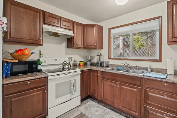a kitchen with stainless steel appliances a stove sink and cabinets