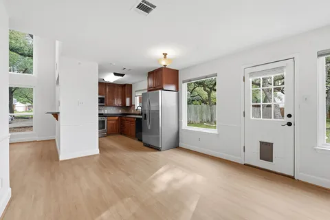a view of a livingroom with wooden floor and staircase