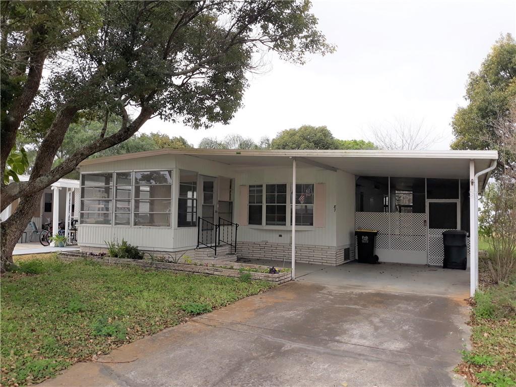 a front view of a house with a garden and plants