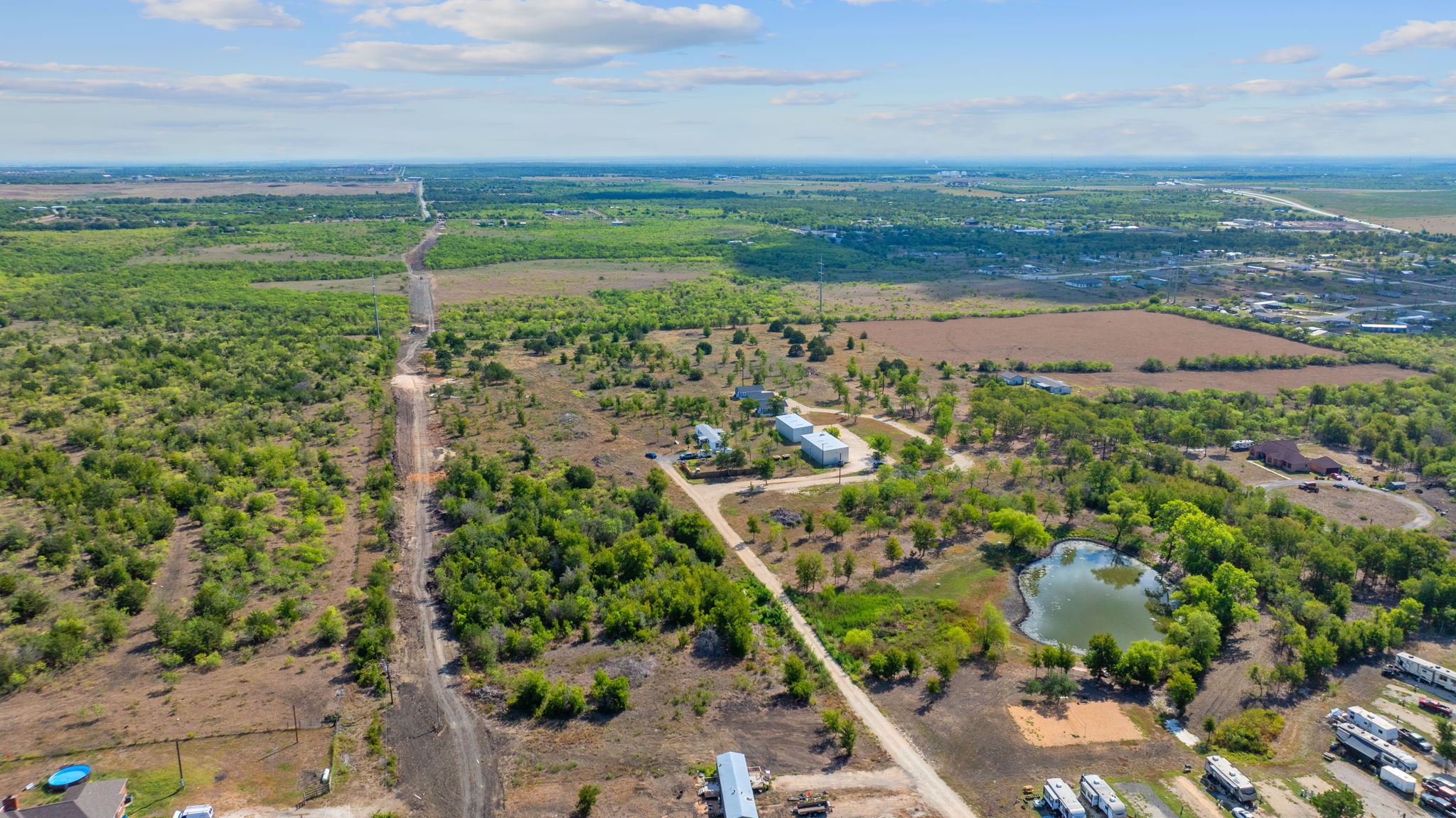 1087 Schubert Lane, Unit B Kyle, TX 78640 - Photo 4 of 19 Aerial view of sparsely populated area with a nearby body of water