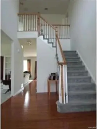 a view of entryway and hall with wooden floor