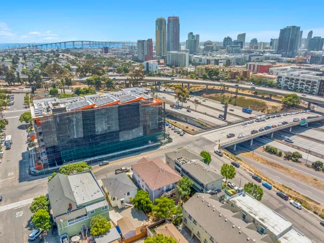 an aerial view of a house with a yard and a wooden bench