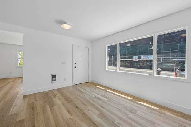 wooden floor in an empty room with a window