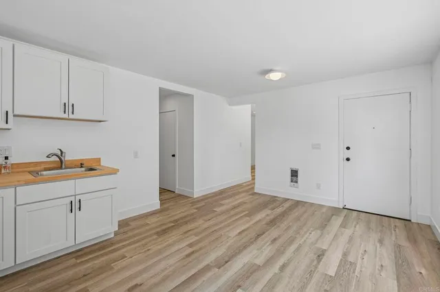 a view of a kitchen with wooden floor