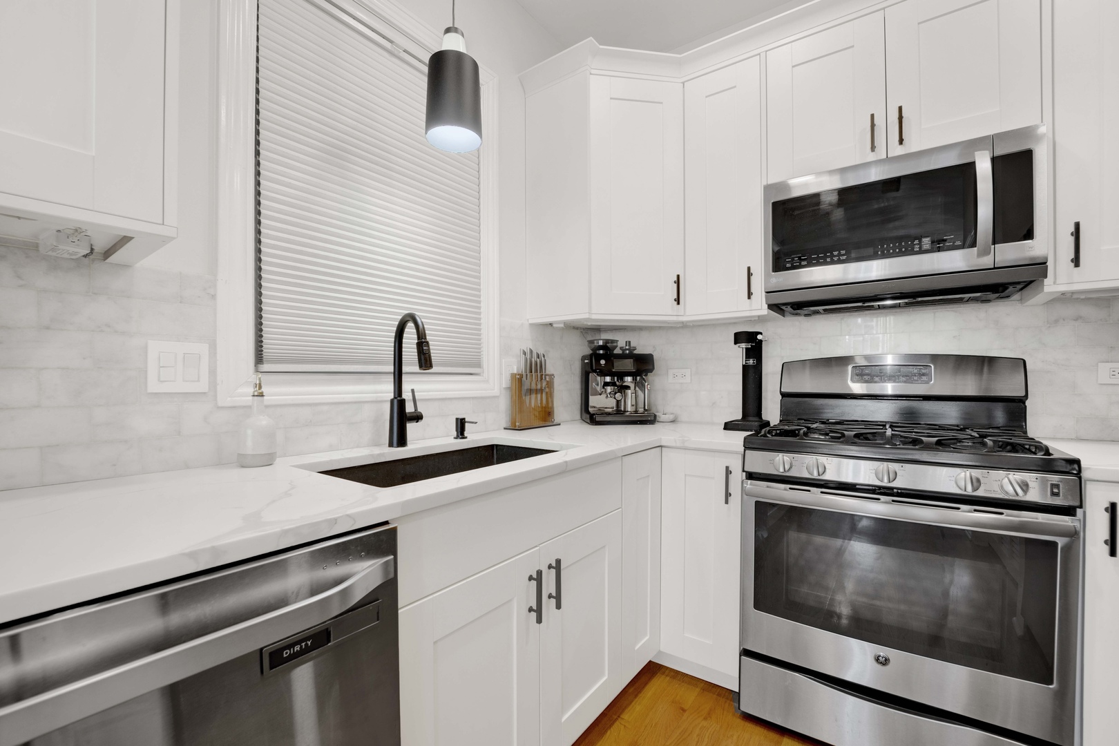 856 West Buckingham Place, Unit 3SW Chicago, IL 60657 - Photo 7 of 23 a kitchen with stainless steel appliances a stove a microwave and sink
