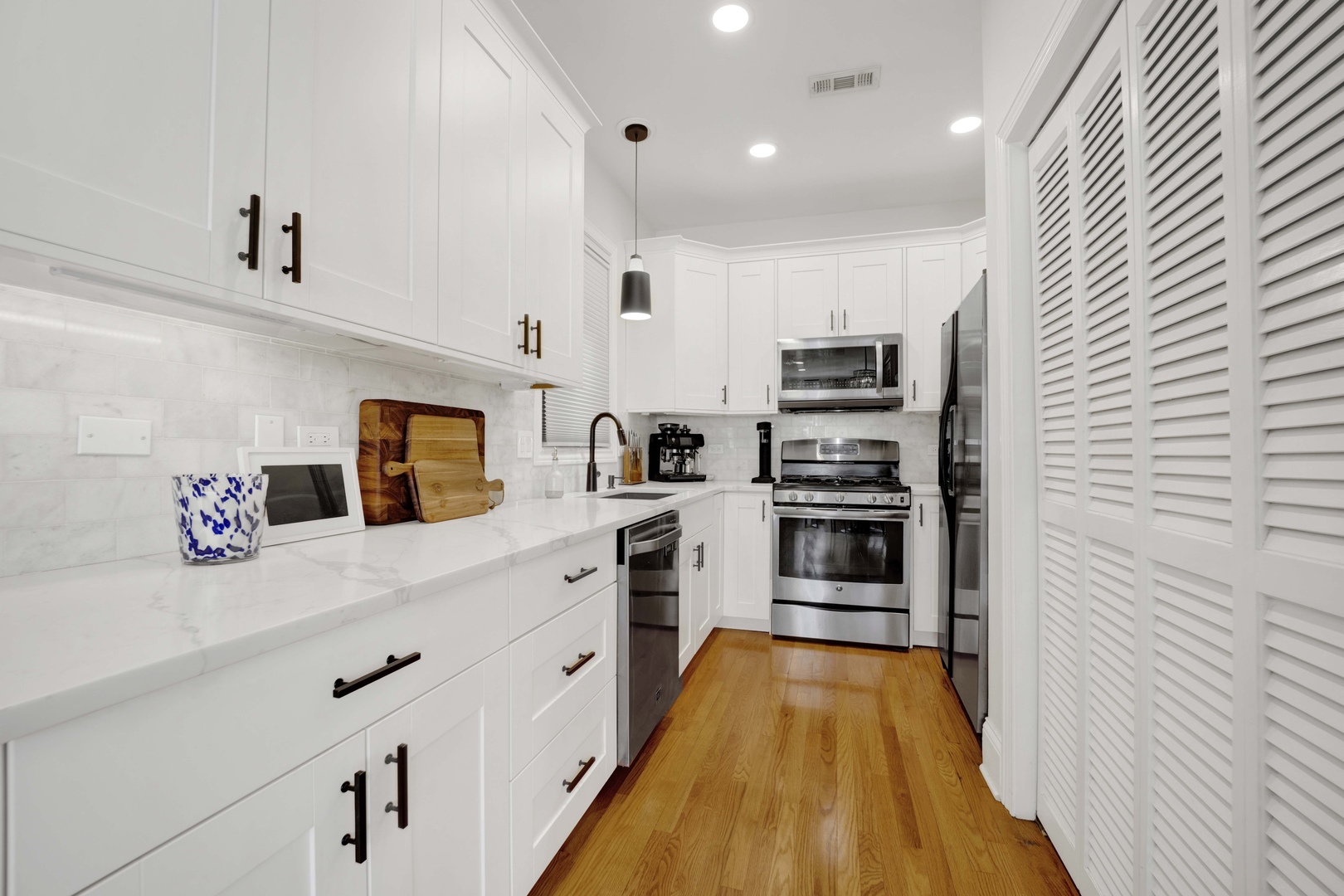 856 West Buckingham Place, Unit 3SW Chicago, IL 60657 - Photo 9 of 23 a kitchen with stainless steel appliances a stove top oven a sink and a refrigerator