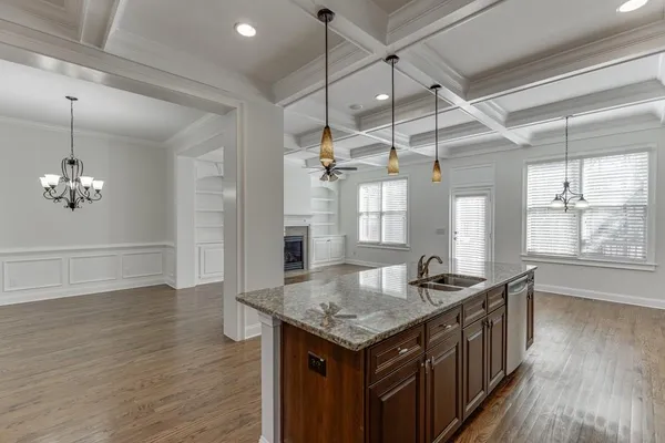 a view of a room with wooden floor and ceiling fan