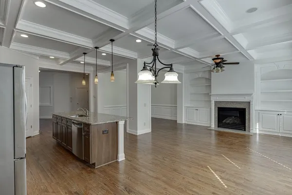 wooden floor chandelier and windows in a room