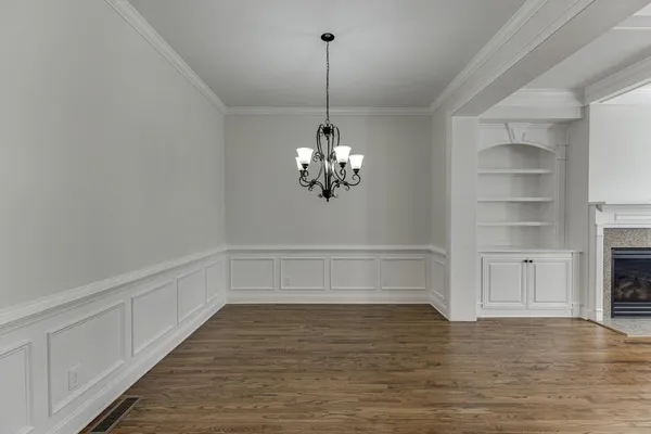 wooden floor fireplace and windows in an empty room