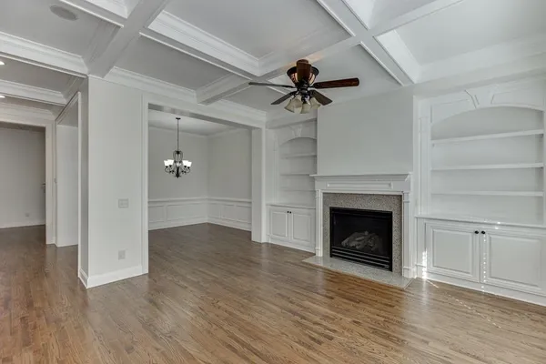 an empty room with a window and a ceiling fan