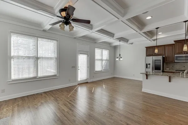 an empty room with a ceiling fan and a window