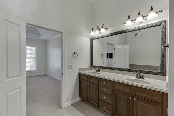 a bathroom with a granite countertop sink a toilet and bathtub