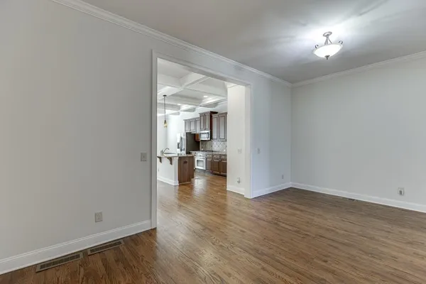 a kitchen with stainless steel appliances granite countertop a sink a stove and a refrigerator