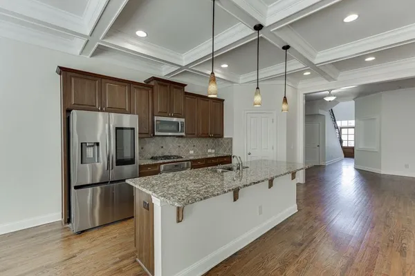 an empty room with wooden floor and a fireplace