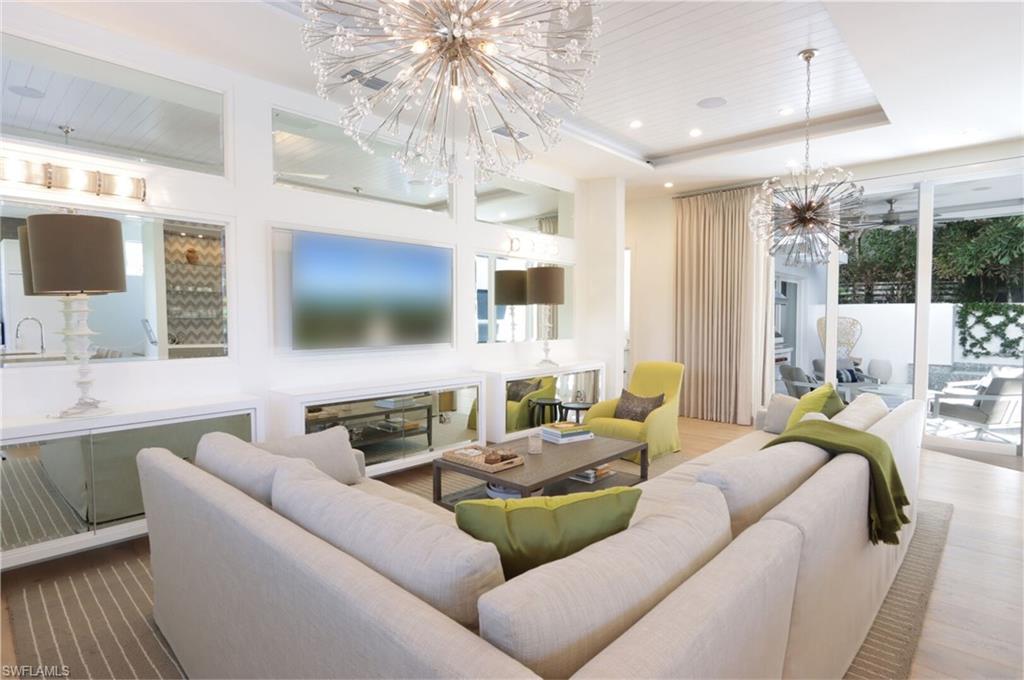 675 2nd Street South Naples, FL 34102 - Photo 3 of 41 a living room with furniture and a flat screen tv