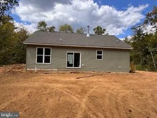 an empty room with fireplace and windows