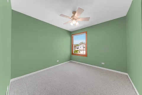 a view of a room with a fan and a window