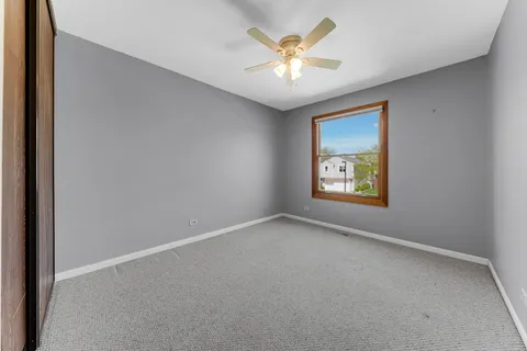 an empty room with a window and wall painting