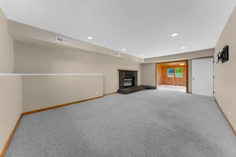 a view of empty room with a fireplace