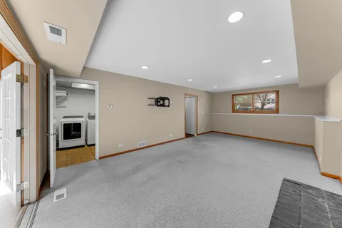 a view of a big room with windows and fireplace