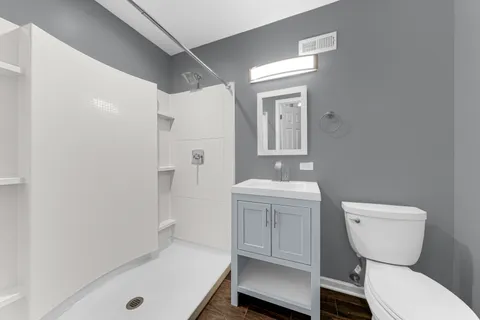 a bathroom with a sink toilet and shower