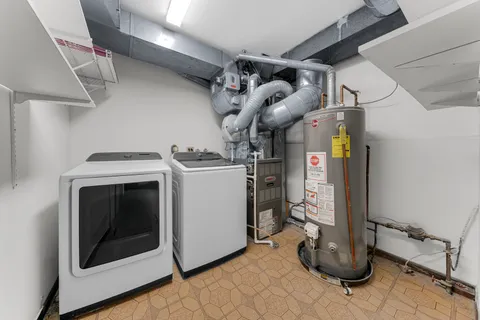 a view of a storage and utility room with washer and dryer