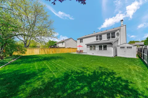 a view of house with backyard