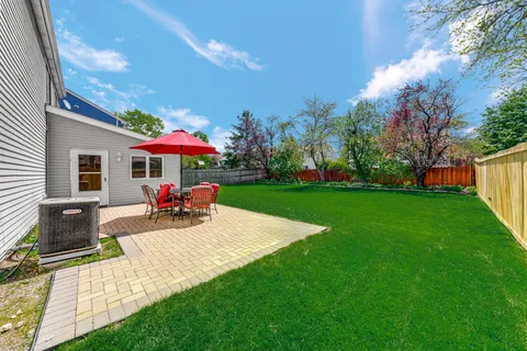 a view of a house with backyard porch and sitting area