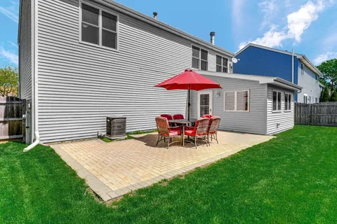 a view of a house with a yard and sitting area