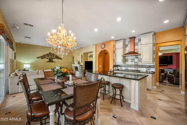 a view of a dining room with furniture and chandelier
