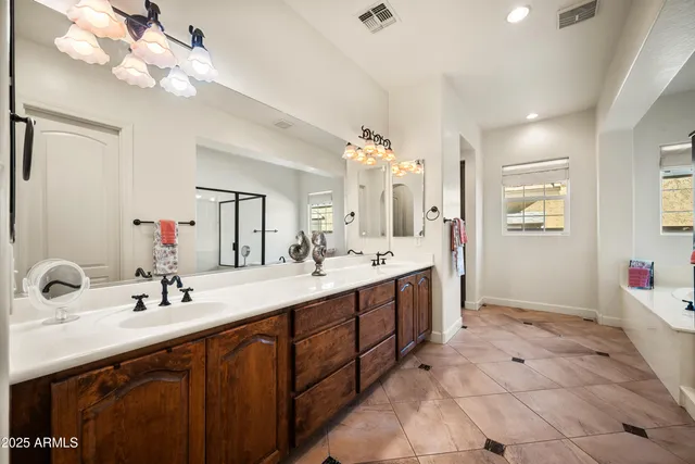 a spacious bathroom with a double vanity sink mirror and