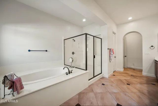a bathroom with a tub sink and mirror