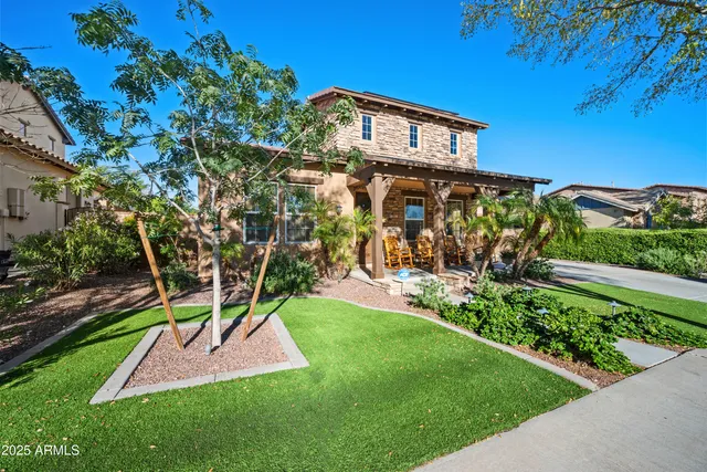 a view of a yard with plants and a bench