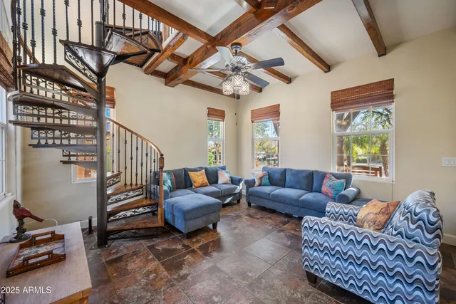 a living room with furniture a couch and a window