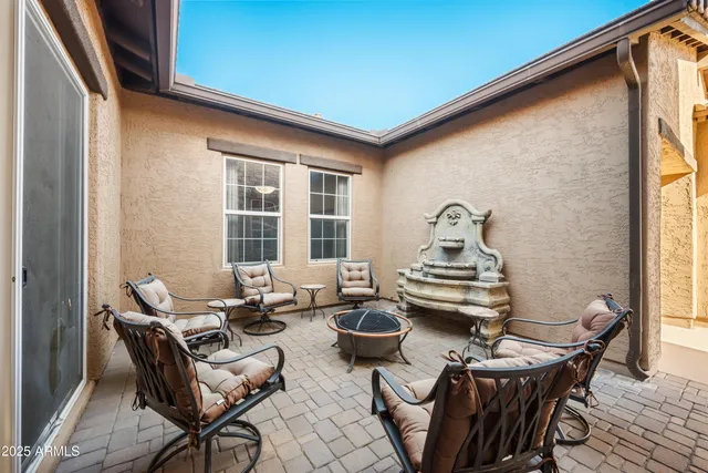 a table and chairs in front of a window