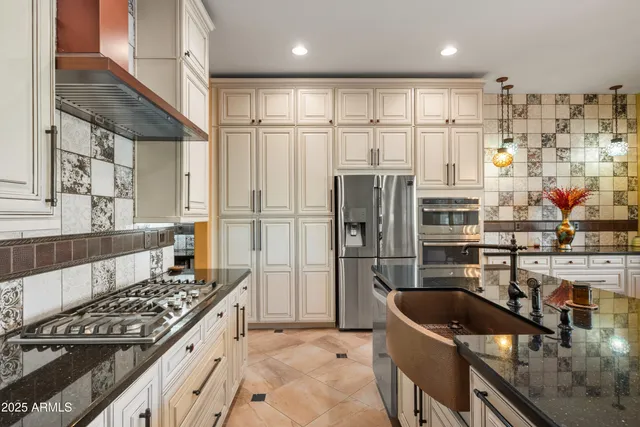 a kitchen with stainless steel appliances granite countertop a sink stove and refrigerator